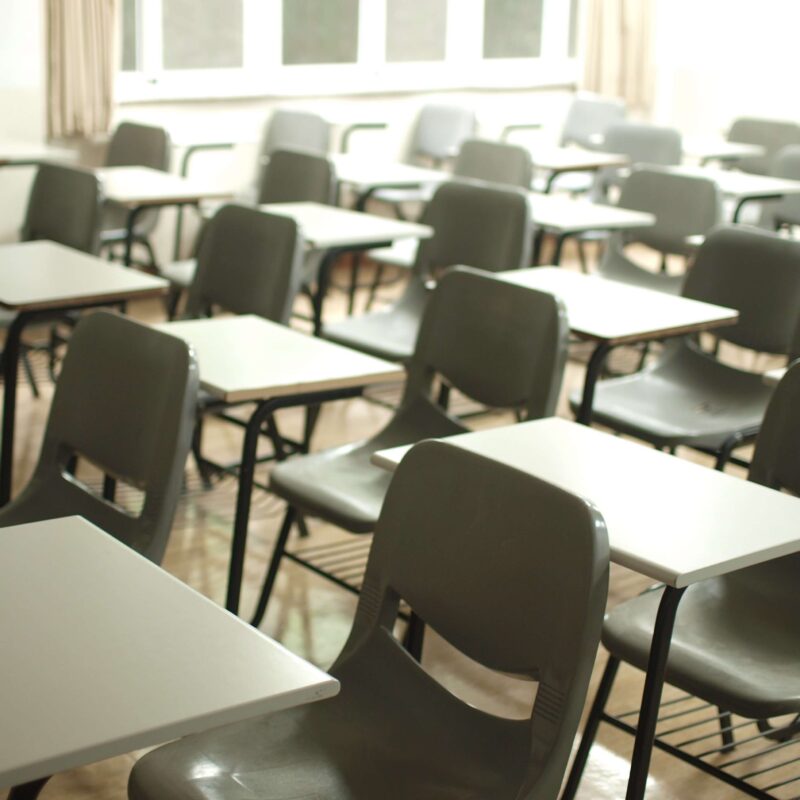 classroom chairs and desks in a row with a school intercom
