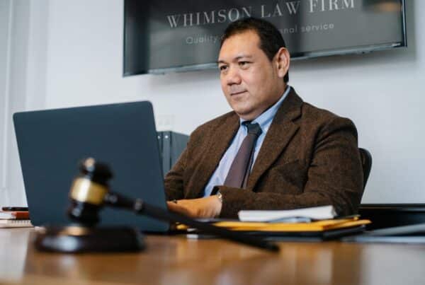 male lawyer uses videoconferencing in courtroom