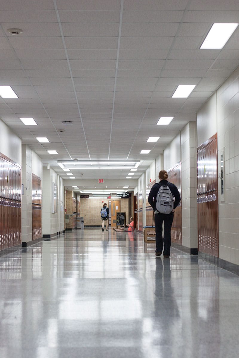 School hallway lined with lockers, covered by the distributed speaker and emergency notification coverage Marshall Industries designs for common areas.